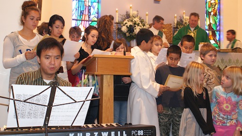 Organist, Neil Estanislao is playing in the sanctuary the Prayer of St. Francis – “Make Me a Channel of Your Peace” with children singing during the Offertory.  Bishop Anthony Mikovsky is celebrating the Holy Mass with clergy assisting Fr. Senior Wieslaw Pietruszka, Fr. Joseph Cyman, Pastor, Fr. Stanley Kural and Deacon David Gaydos. 