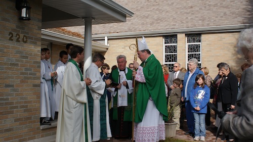 Bp. Anthony Mikovsky is blessing the rectory of Holy Cross Church after the Mass on Sunday November 15, 2009.  It was beautiful weather that day with dozens of people participating in this special celebration of Holy Cross Church family.
